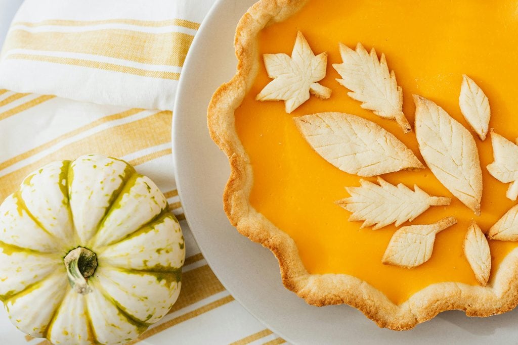 Pumpkin pie with autumnal design pastry