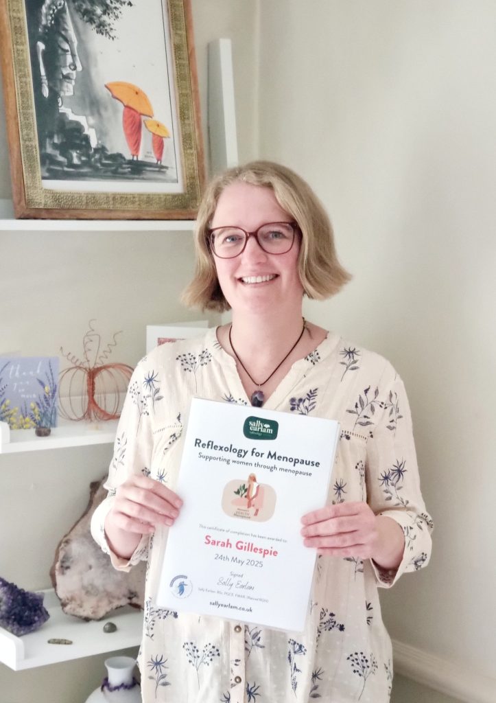 Reflexologist Sarah Gillespie holding her certificate for menopause training